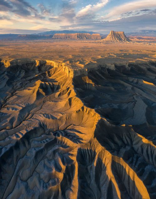 Vertorama of sunrise over the Utah badlands, spot our cars Badlands, Utah