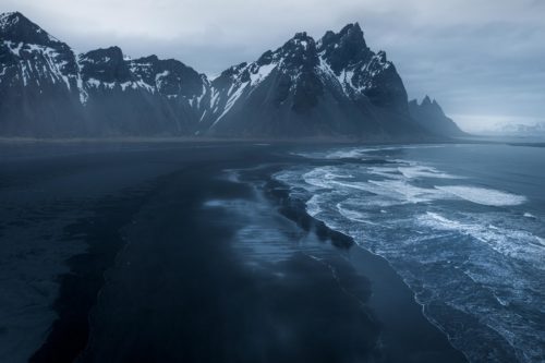 The Vestrahorn peaks reflected in the black sand beach at Stokksnes Stokksnes, Iceland, Vestrahorn