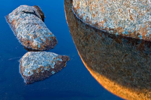 Dolerite boulders in a pool reflecting blue sky on Mount Wellington/Kunanyi dolerite, Mount Wellington, Kunanyi, Tasmania, Hobart