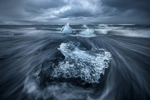 Moody textured grey skies often bring out the blues in the ice at the diamond ice beach jokulsarlon, Iceland, diamond ice beach