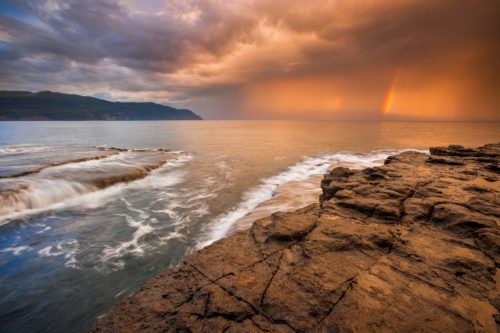 Golden light as a rainstorm clears over the Tasman Peninsula Tasman Peninsula, Tasmania