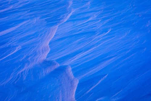 Ice sculpted by the wind catching the sunset glow at Detifoss Iceland, abstract