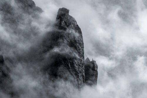 Fog swirls around mountains, with trees giving scale to the majestic landscape of Alaska Petersburg, fog, Alaska