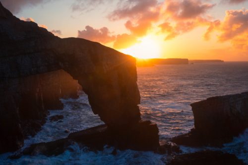 The iconic Green Bridge of Wales at sunrise Green Bridge of Wales, Pembroke