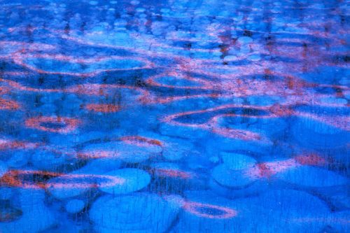 Methane bubbles on Abraham Lake and sunrise light Canada, Canadian Rockies, Abraham Lake