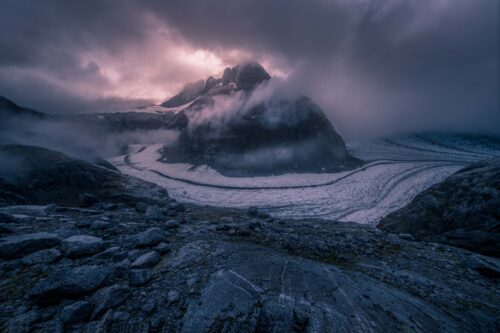A peak in the Boundary Range rises above rings of low lying clouds Boundary range, Alaska