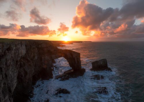 A fiery sunrise at the Green Bridge of Wales Green Bridge of Wales, Pembroke