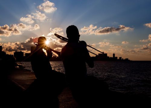 The esplanade of Havana known as the Malecon abuzz at sunset Malecon, musicians, Havana, Cuba