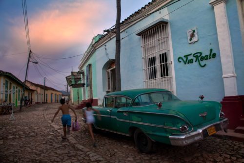 Kids running along the cobblestone streets of Trinidad Trinidad, Cuba