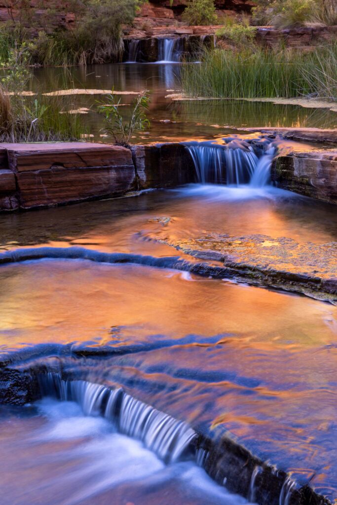 Coloured reflections in on of many cascades characteristic of Karijini NP Karijini, Western Australia, reflections