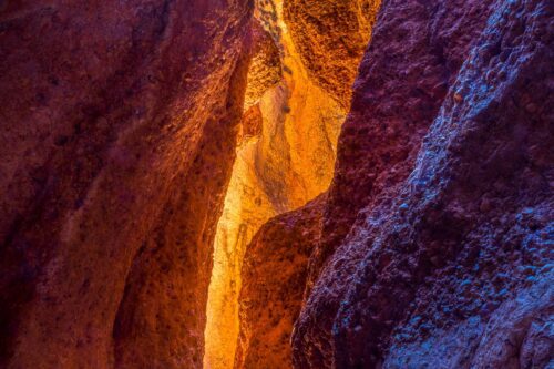 Bands of colours from reflected light within a canyon in Purnululu NP Echidna chasm, Purnululu, Bungle Bungles, Western Australia