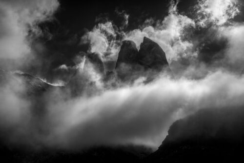 Virtually unknown peaks in the Chilean Fiords appearing as the marine layer clears Chilean fiords, Chile, Patagonia, Coyhaique, black and white