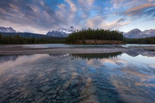 Mount Christie towering over the Athabasca River with both reflected light and translucent waters Jasper, Canadian Rockies, Icefields Parkway, Mount Christie