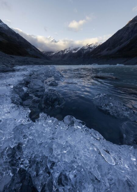 After clear skies all afternoon suddenly clouds filled in short order at sunset Mount Cook, Aoraki, Hooker Lake, New Zealand