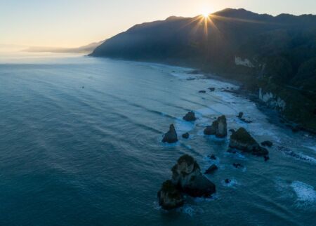 Clear skies and some mist meant that sunrise was better captured from above West Coast, New Zealand, Motukiekie