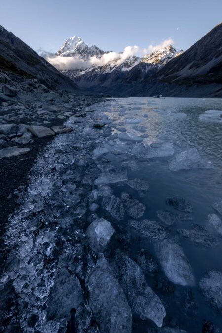 Ice fragments in front of mighty Mount Cook Hooker Lake, Aoraki, Mount Cook, New Zealand