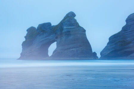 Moody and fog at the sea stacks of Wharariki Wharariki, New Zealand, Golden Bay