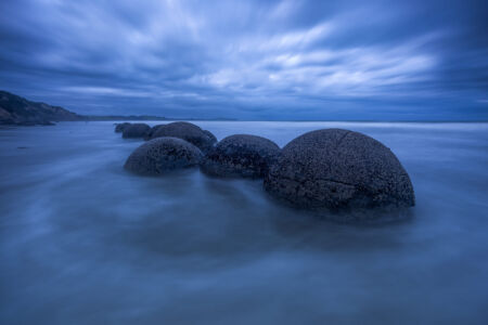 The Moeraki Boulders looking like eggs incubating in the primordial soup Moeraki Boulders, New Zealand