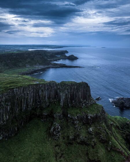 Feeling like being at the top of the world viewing the majesty of the Causeway Coast both from this ledge and my drone Causeway Coast, Northern Ireland