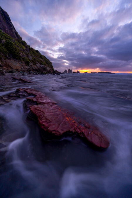 Sunset reflected in the coloured rocks of the west coast Motukiekie, west coast, New Zealand, Greymouth