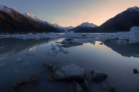 Ice fragments from glaciers floating in Tasman Lake at sunrise Aoraki, Mount Cook, Tasman Lake